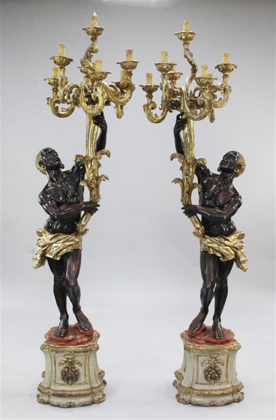 A pair of Venetian carved, painted and parcel gilt blackamoor torcheres, H.6ft 6in.